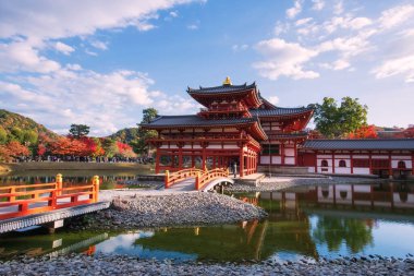 Sonbaharda, Uji, Kyoto, Japonya 'da, renkli akçaağaç yaprakları ve ufuk çizgisi yansıması olan Phoenix Byodo-In Salonu veya Byodoing Tapınağı. Aralık ayında Kansai 'de turistler için ünlü bir tatil beldesi.