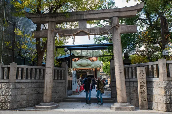 Torii kapısındaki yabancı turistler, sonbaharda Japonya 'nın Osaka kentindeki Namba Yasaka jinja kentinin ikonik aslan başkanını ziyaret edecekler. Kansai 'yi görmek ve ibadet etmek için seyahat yeri.
