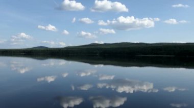 Yazın sakin ve berrak bir gölde kameralar soldan sağa döner..