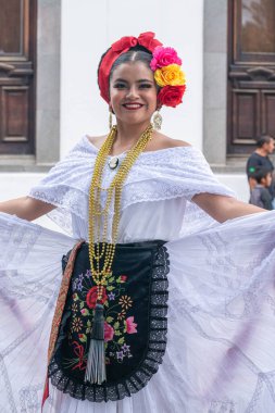 COATEPEC, VERACRUZ, MEXICO- SEPTEMBER 25, 2022: Portrait of a smiling girl dressed with traditional clothes from Veracruz at Coatepec, Veracruz, Mexico