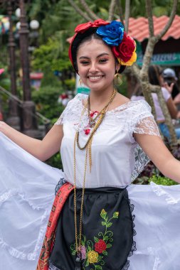 COATEPEC, VERACRUZ, MEXICO- SEPTEMBER 25, 2022: Portrait of a smiling girl dressed with traditional clothes from Veracruz at Coatepec, Veracruz, Mexico