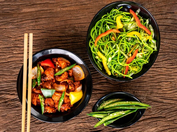 stock image Asian food on wooden background with chop sticks