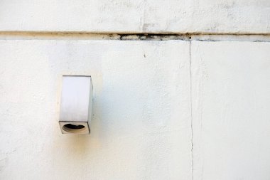 white brick wall with a metal handle.