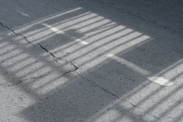 the shadow of a white wire on the street
