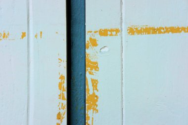 the old blue wooden wall with peeling paint texture.