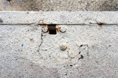 bir evin duvarında delikleri olan beton bir duvar