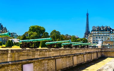 Historic cannons at les Invalides with Eiffel Tower in Paris, France