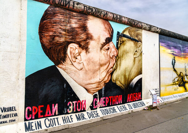 Berlin, Germany - August 21, 2022: My God, Help Me to Survive this Deadly Love, a graffiti painting by Dmitri Vrubel at the East Side Gallery of the Berlin Wall