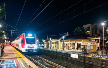 Electric commuter train arriving at Menlo Park Station in San Francisco Bay Area in California, United States clipart