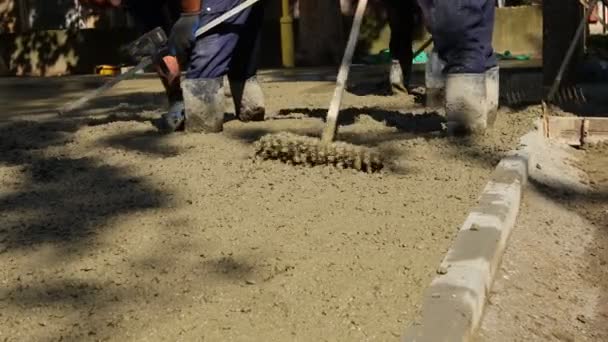 Construction Workers Riggers Using Rake Spreading Leveling Concrete Covering Square — Stockvideo