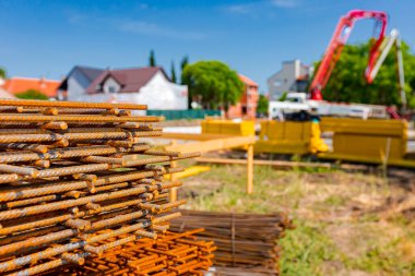Pile of rusty rectangle steel reinforcement for concrete ready for installation placed at construction site. 