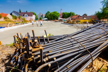 Tied bundles of steel bars reinforcement ready for installation, classified by the bending shape at construction site.