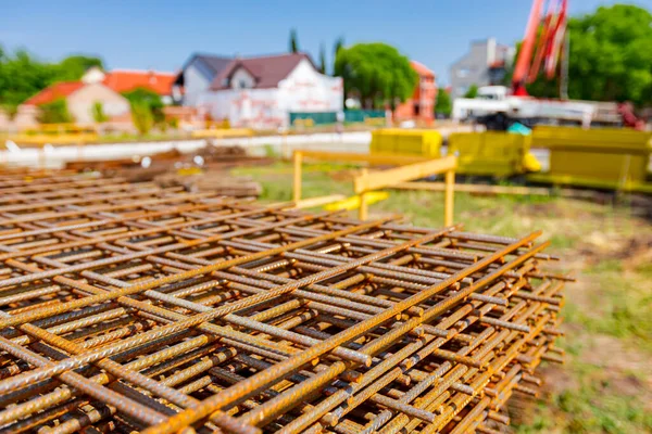 Pile of rusty rectangle steel reinforcement for concrete ready for installation placed at construction site. 