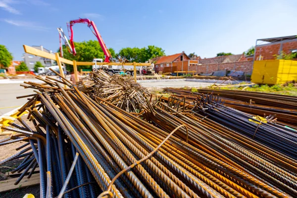 Tied bundles of steel bars reinforcement ready for installation, classified by the bending shape at construction site.
