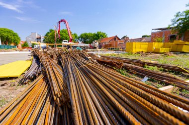 Tied bundles of steel bars reinforcement ready for installation, classified by the bending shape at construction site.