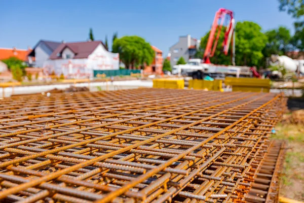 Pile of rusty rectangle steel reinforcement for concrete ready for installation placed at construction site. 