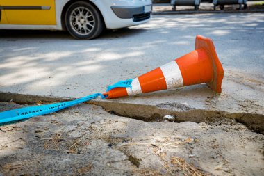 Düşen turuncu renkli beyaz floresan şeritli koni trafiği yönlendirmek ve uyarmak için yolda..