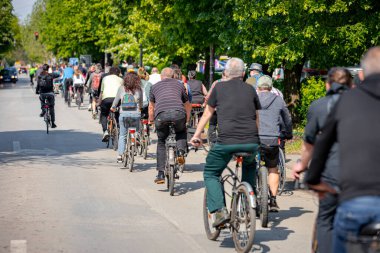 Bisiklet süren, şehirde bisiklete binen, kalabalık içinde araba kullanan bir grup genç, trafikteki ve kentsel çevredeki bisikletçiler için tehlikelere dikkat çekmeye çalışıyor.. 
