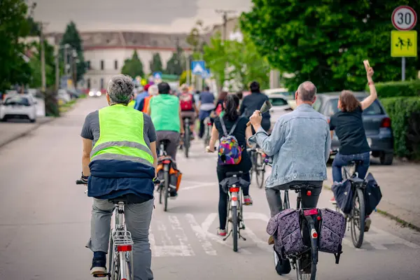 Bisiklet süren, şehirde bisiklete binen, kalabalık içinde araba kullanan bir grup genç, trafikteki ve kentsel çevredeki bisikletçiler için tehlikelere dikkat çekmeye çalışıyor.. 