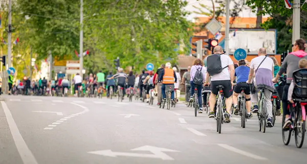 Bisiklet süren, şehirde bisiklete binen, kalabalık içinde araba kullanan bir grup genç, trafikteki ve kentsel çevredeki bisikletçiler için tehlikelere dikkat çekmeye çalışıyor.. 