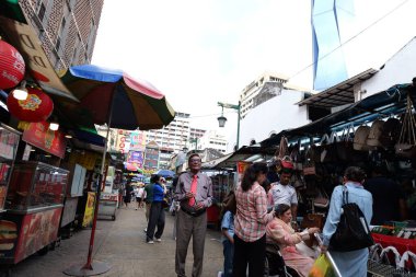 Kuala Lumpur, Malaysia November 18 2024 Shoppers on Jalan Petaling in Chinatown, Kuala Lumpur: A Bustling Market Scene clipart