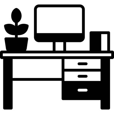 Bilgisayar ve ofis bitkilerinin olduğu masa