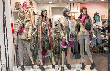 Polonya, Bydgoszcz - 29 Eylül 2022: Moda mağazası VENEZIA. Kadın mankenler şık kışlık giysiler sergilerler. Mağaza vitrininde güzel bebekler