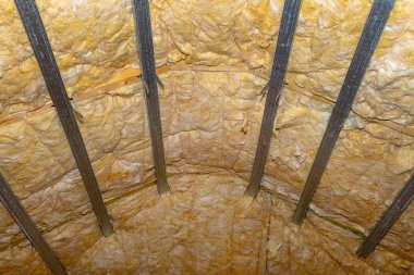Aluminum frame with hangers placed on beams in the attic for mounting plasterboards.