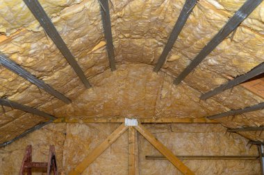 Aluminum frame with hangers placed on beams in the attic for mounting plasterboards.
