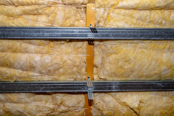 Aluminum frame with hangers placed on beams in the attic for mounting plasterboards