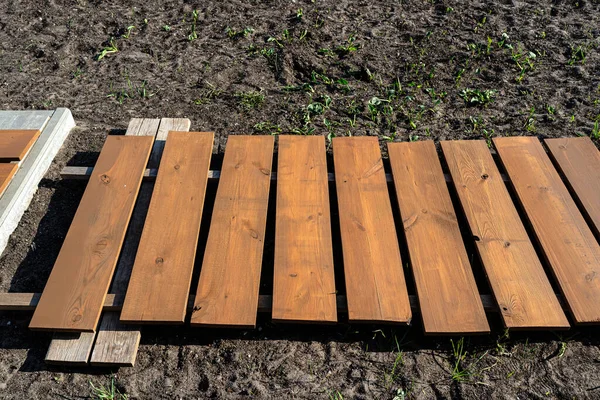 stock image Cut and impregnated boards ready to assemble the vegetable box in Winchester oak.