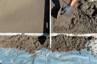 Takviyeyle kaplı bir terasa el yapımı beton dökülüyor..