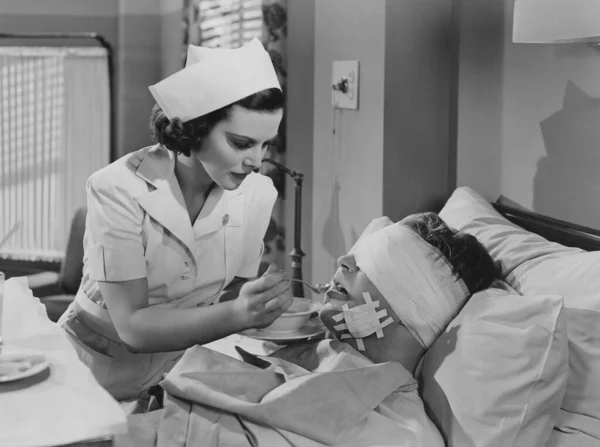 Beautiful Young Nurse Feeding Injured Patient Bandage Covering Eyes Hospital Stock Photo