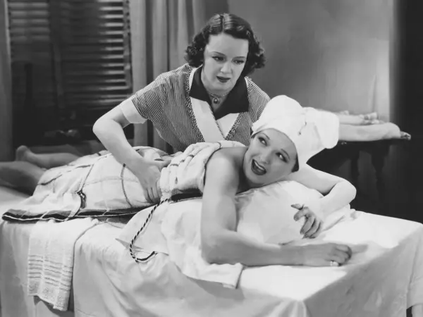 Confident Masseuse Massaging Female Customer Lying Table Spa Royalty Free Stock Photos