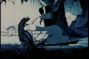 Silindir şapkalı bir adam diğer adamın çorap şapkasını ok ve yayla vuruyor.