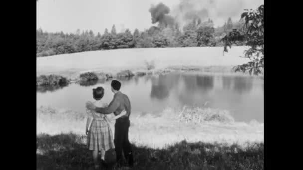 Rear View Couple Watching Forest Fire Pond 1940S — Stock Video
