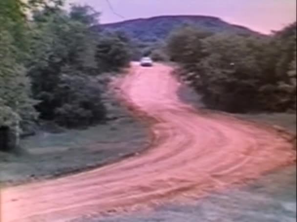 Long Shot Car Driving Dirt Road 1970S — Stock Video