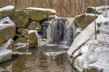 Central Park in winter , waterfall in winter after snow storm