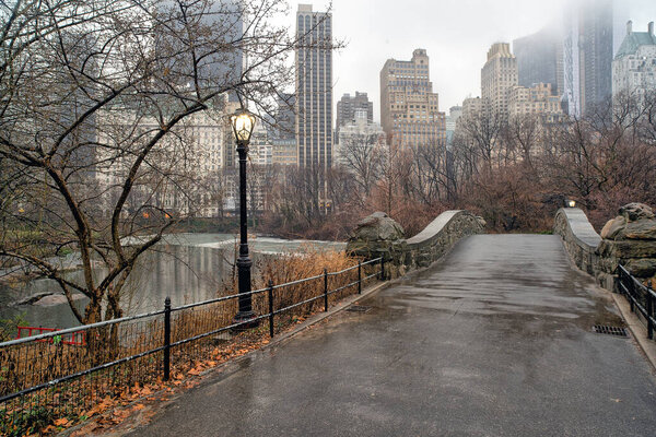 Gapstow Bridge in Central Park in winter on rainy morning