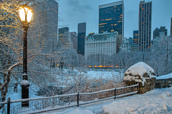 Gapstow Bridge in Central Park during snow storm at dawn