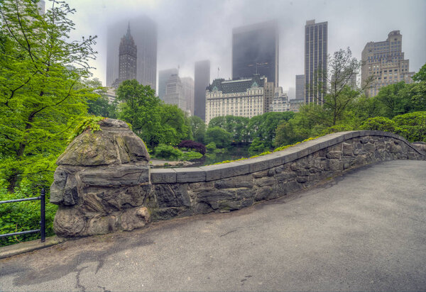 Gapstow Bridge in Central Park on foggy morning in summer