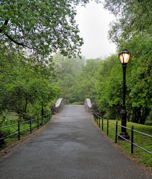 Gapstow Bridge in Central Park in late spring on foggy morning