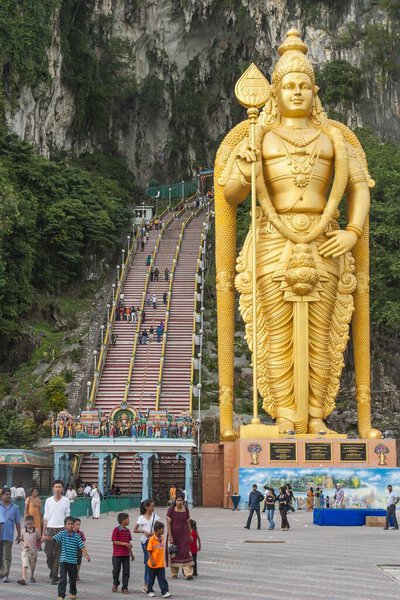 KUALA LUMPUR, MALAYSIA - February 02, 2006. Giant golden statue of Hindu god Lord Murugan outside entrance to Batu Caves, Kuala Lumpur, Malaysia