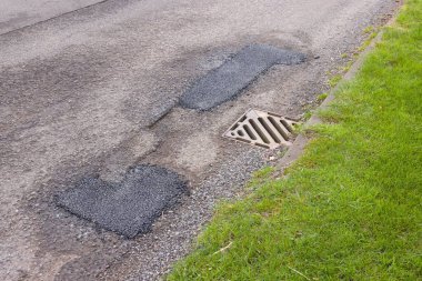 Tamir edilmiş bir köy yolundaki çukur yaması onarılıyor. Birleşik Krallık yol bakımı. Buckinghamshire, İngiltere