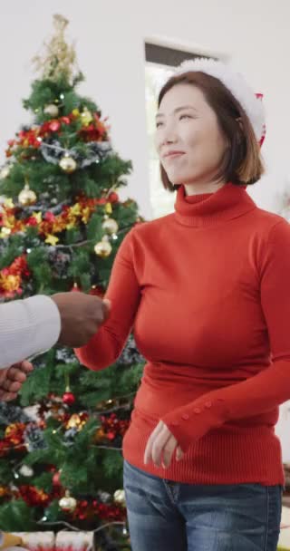 Vertical Video Happy Diverse Couple Santa Hats Dancing Christmas Tree — Video