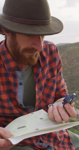 Vertical Video Bearded Caucasian Male Survivalist Map Compass Exploring Wilderness — Stock Video