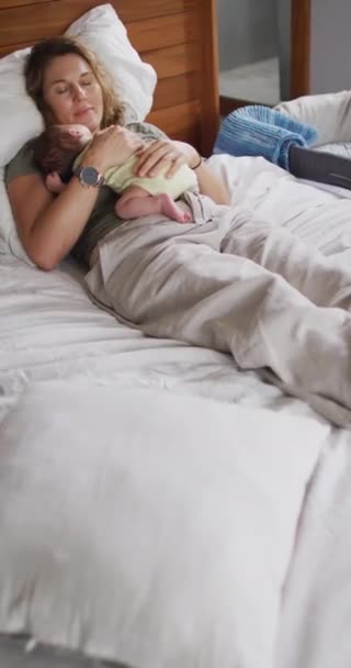 Vertical Video Tired Caucasian Mother Sleeping Newborn Baby Bed Motherhood — Stock Video