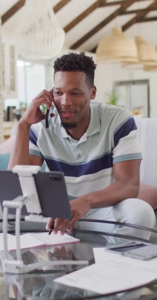 スマートフォンで話している幸せなアフリカ系アメリカ人男性の垂直ビデオ 家庭だけで質の高い時間を過ごす — ストック動画