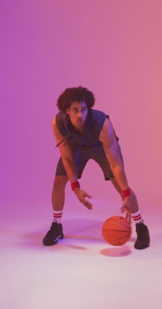 Vertical Video Biracial Male Basketball Player Ball Pink Background Sports — Stock Video