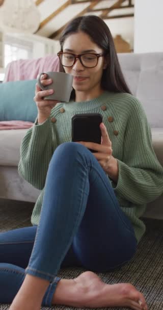 Vertical Video Biracial Woman Using Smartphone Drinking Coffee — Stock Video